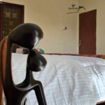 Sankofa guest house accra ghana hotel airbnb deluxe bathroom portrait with statue